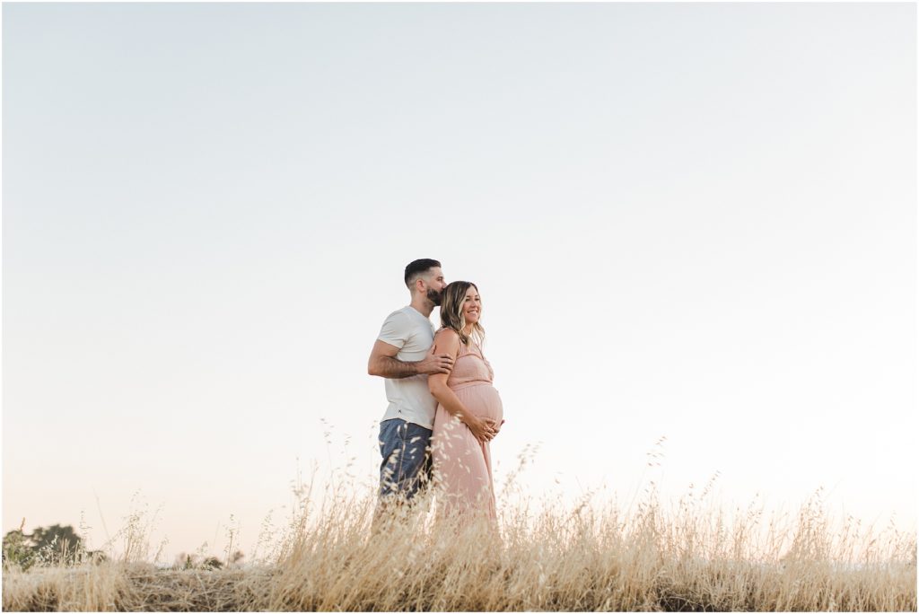 Romantic, golden field maternity session amidst a pandemic with Ashley Carlascio Photography.
